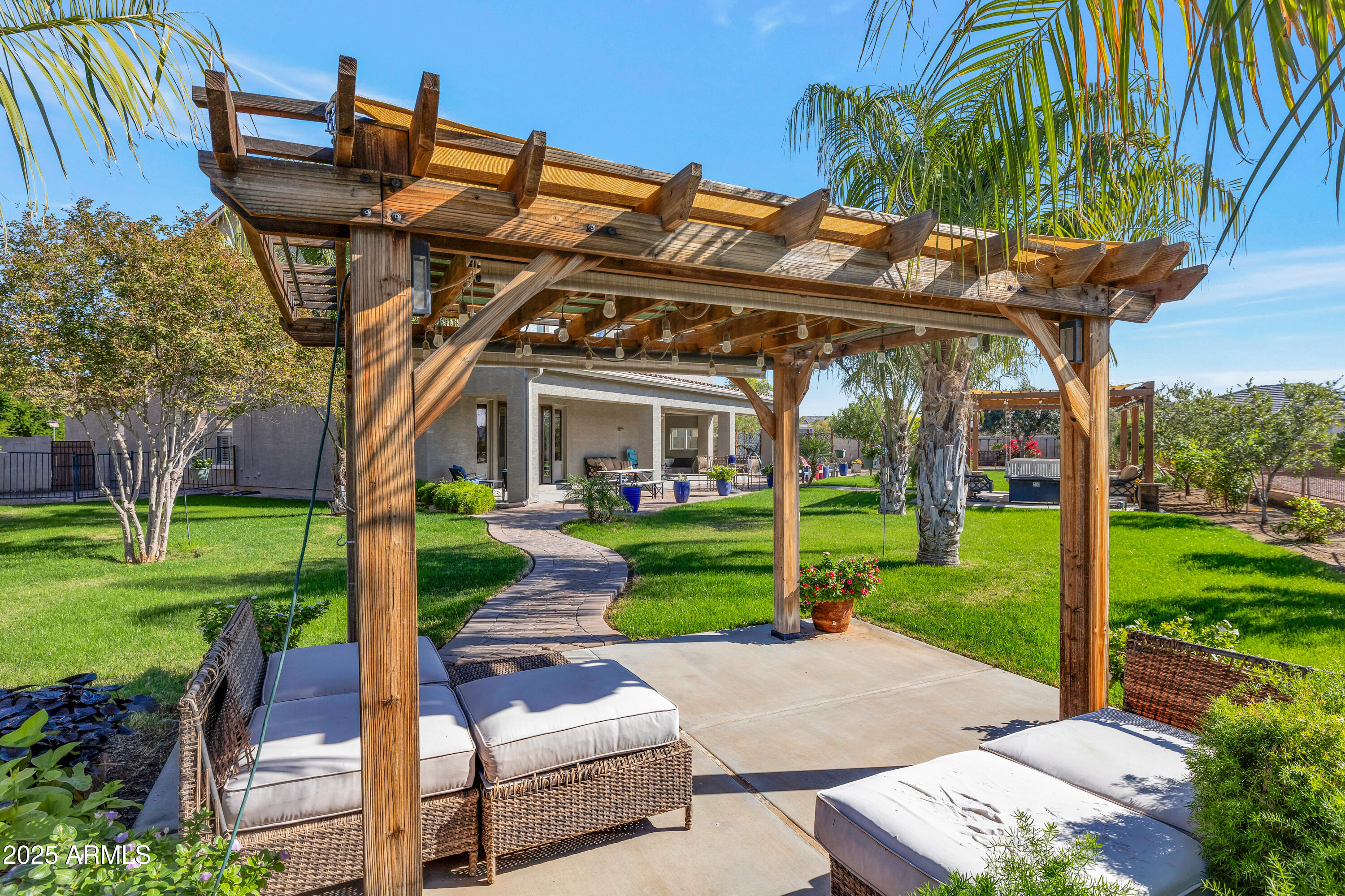 16896 North Palo Rojo Road Maricopa, AZ 85138 - Photo 34 of 48 a patio with a table and chairs and a yard