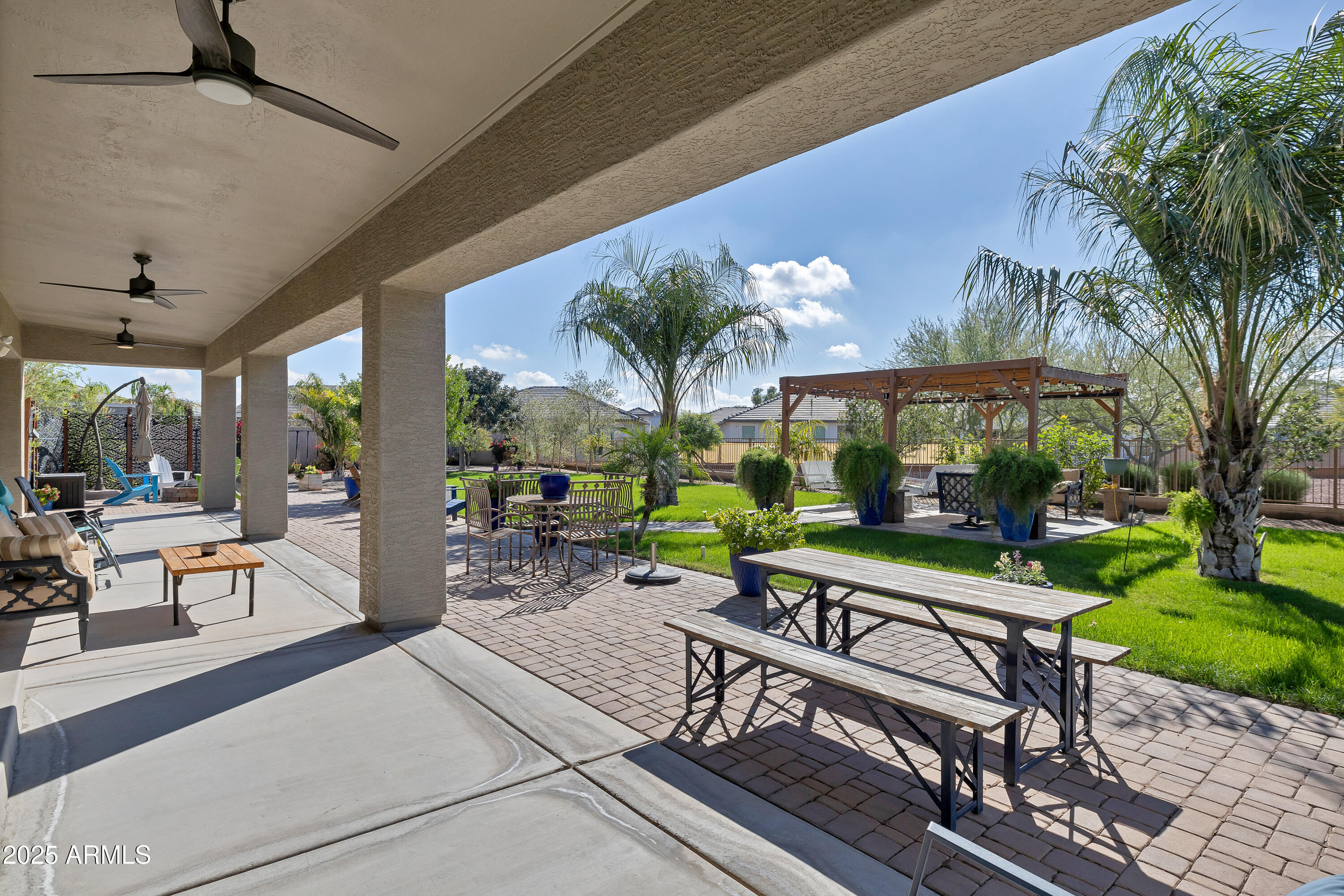 16896 North Palo Rojo Road Maricopa, AZ 85138 - Photo 36 of 48 a view of a patio with a table and chairs under an umbrella