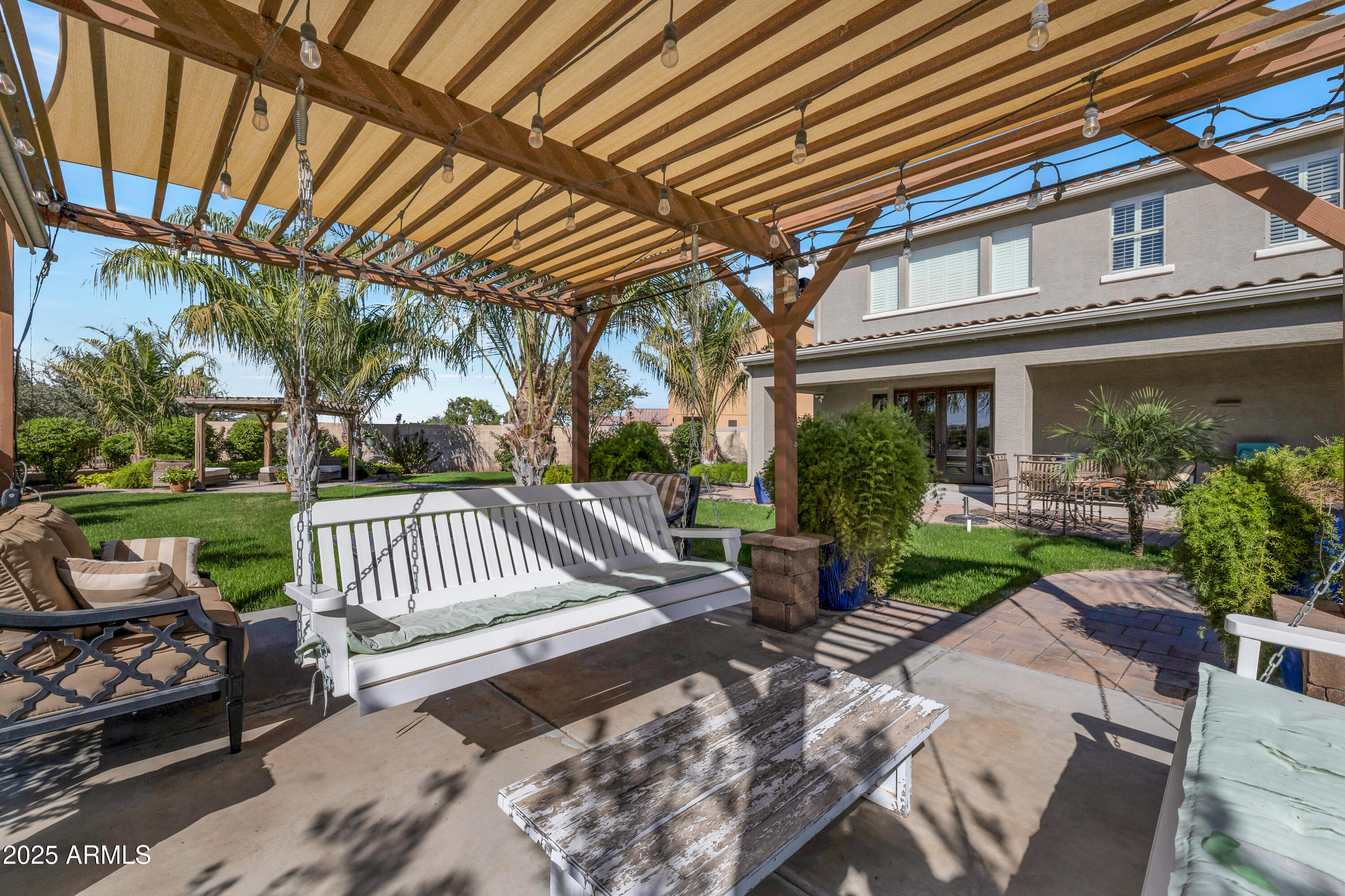 16896 North Palo Rojo Road Maricopa, AZ 85138 - Photo 37 of 48 a view of a chair and tables in the patio in front of a house