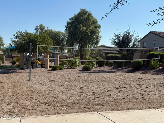 a view of a park that has a fountain and a street