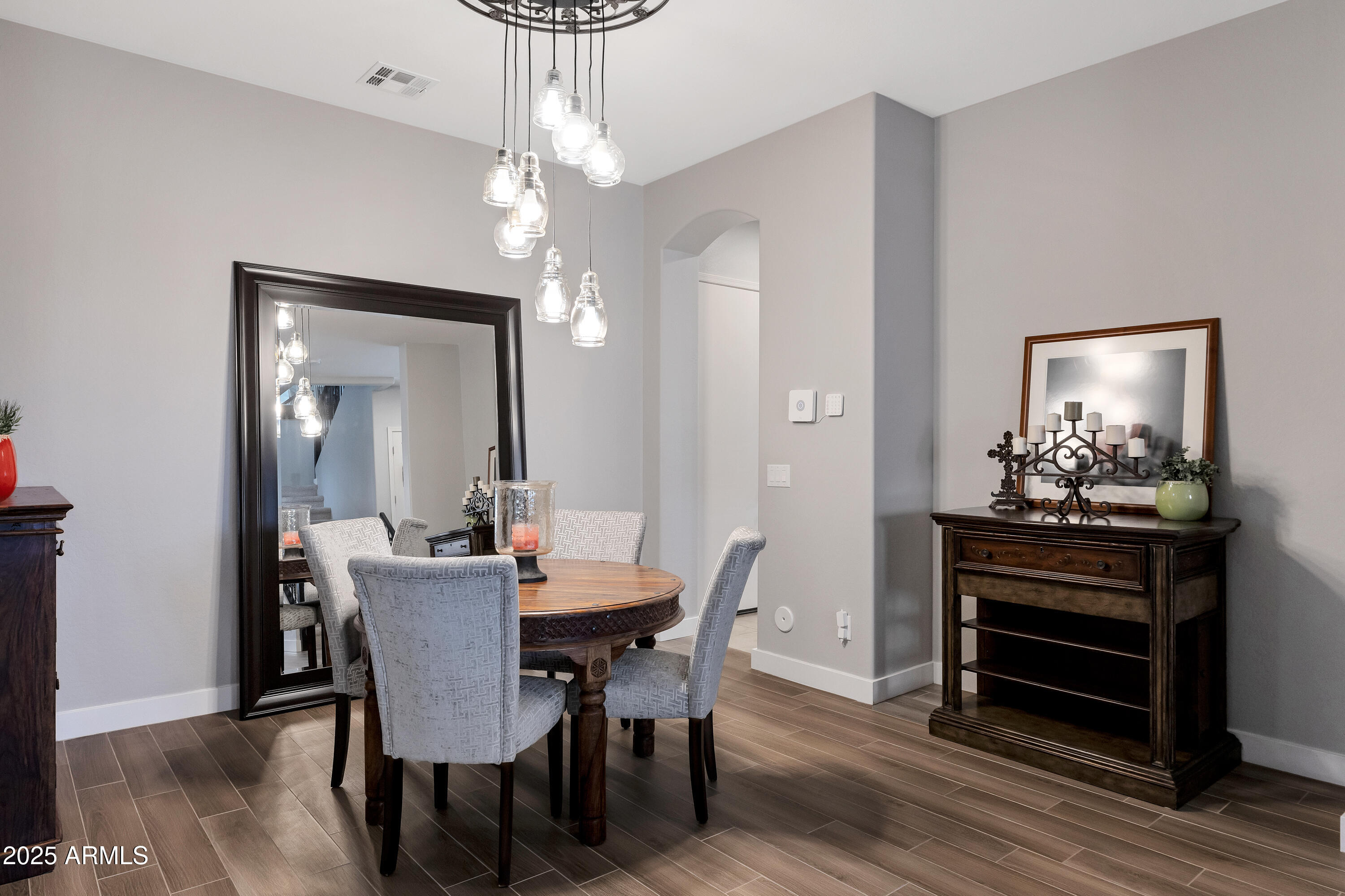 16896 North Palo Rojo Road Maricopa, AZ 85138 - Photo 4 of 48 a view of a dining room with furniture and wooden floor