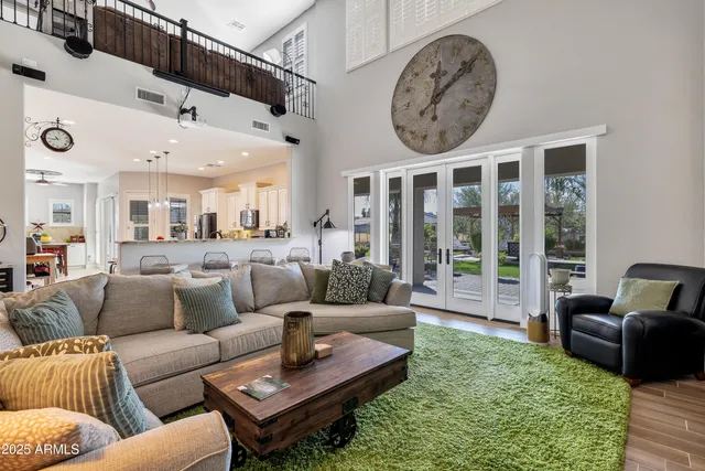 a living room with furniture a rug and a large window