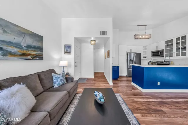 a living room with furniture and painting on the wall