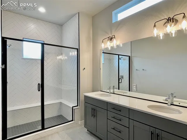 a bathroom with a double vanity sink mirror and shower