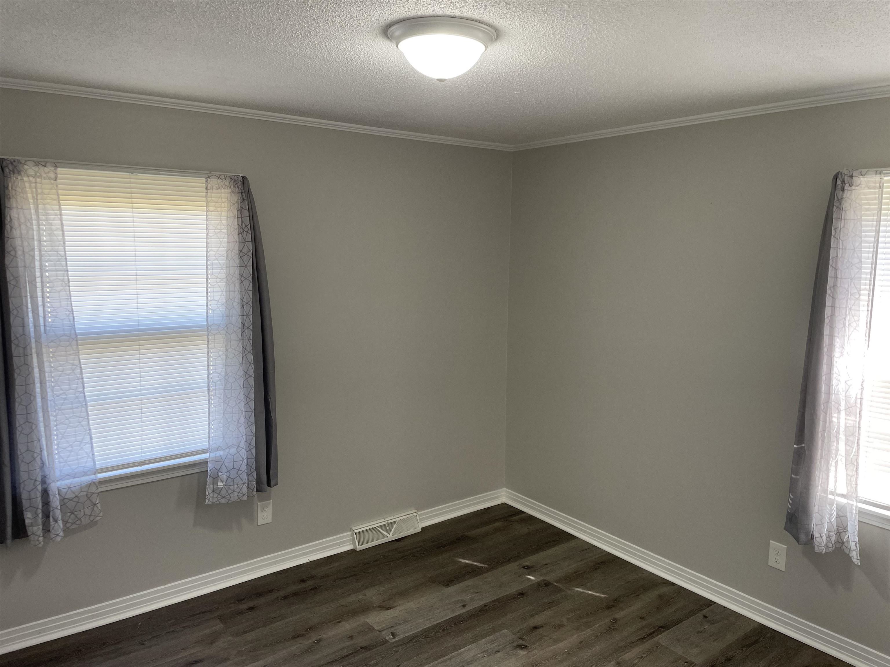 235 Paine Road Savannah, TN 38372 - Photo 17 of 28 an empty room with wooden floor and windows