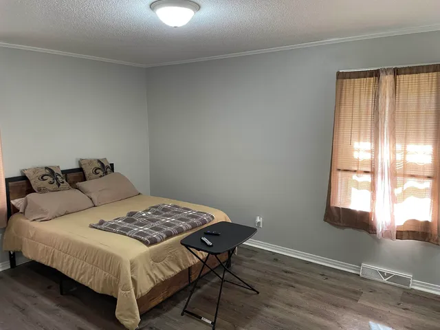 a bedroom with a bed and a window