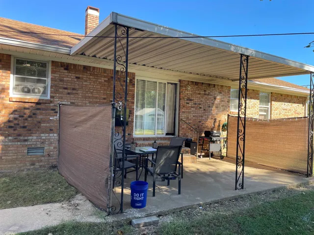 a view of a patio with table and chairs