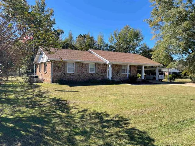 a front view of a house with a swimming pool