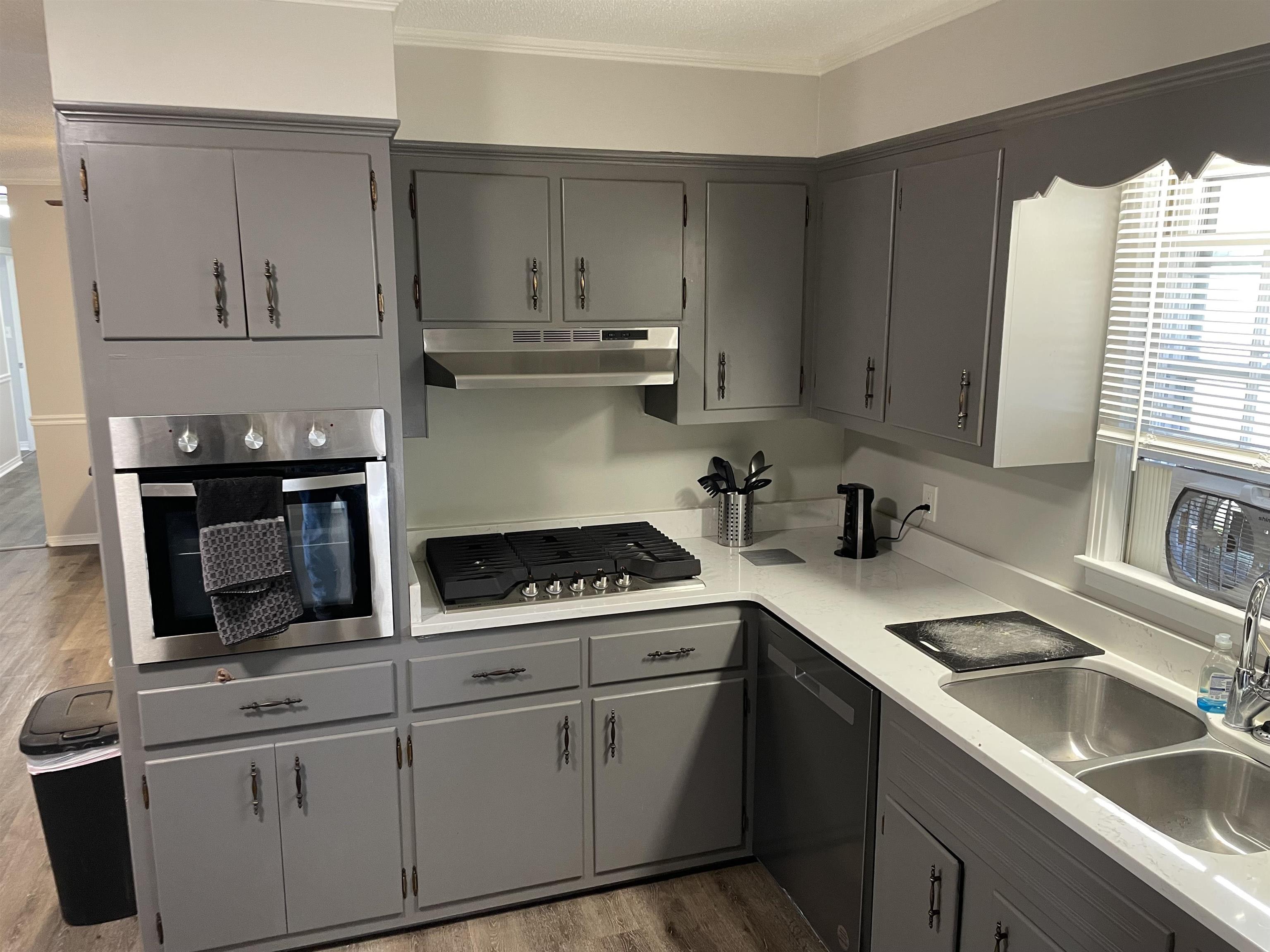 235 Paine Road Savannah, TN 38372 - Photo 3 of 28 a kitchen with white cabinets and appliances