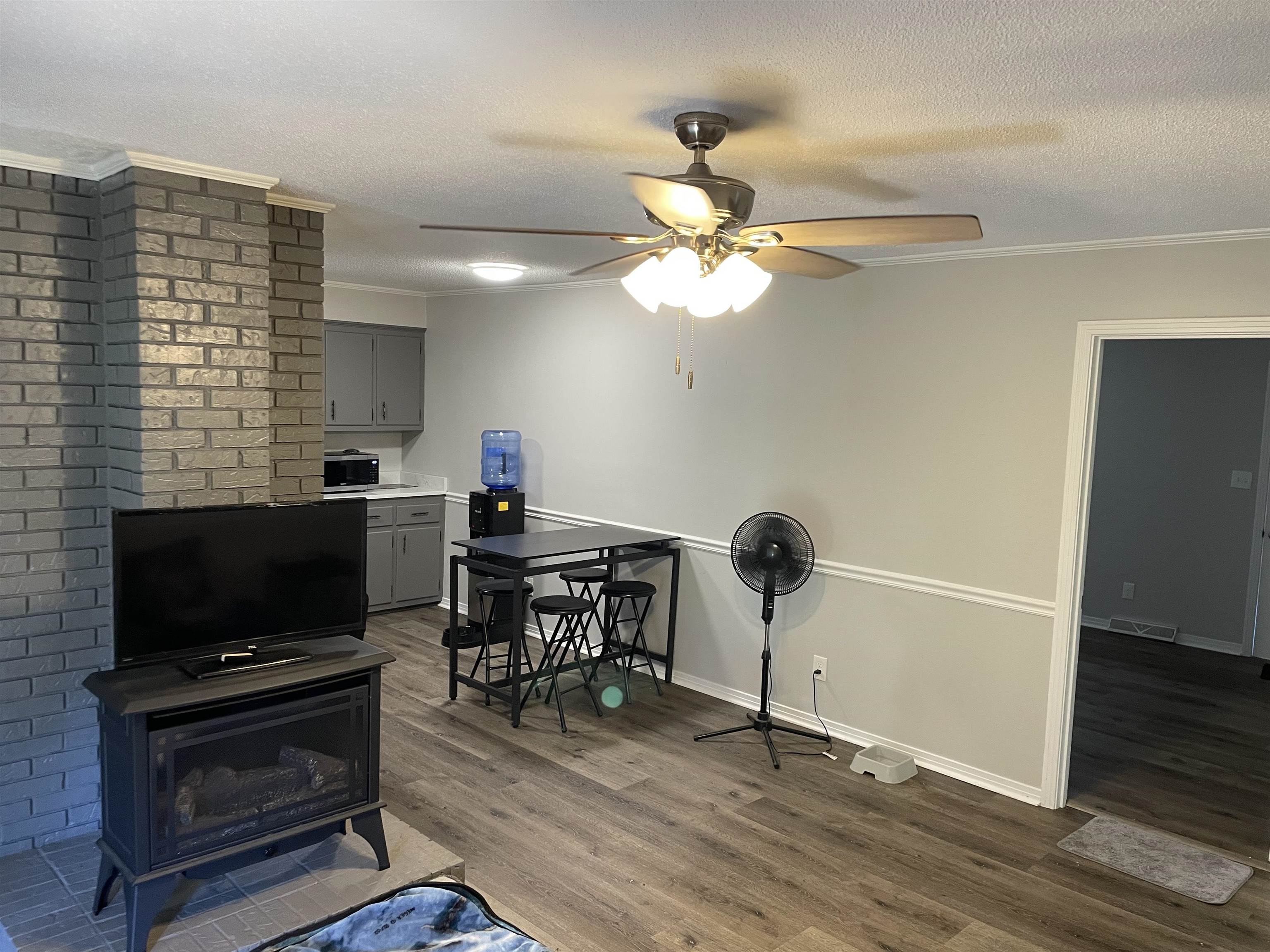 235 Paine Road Savannah, TN 38372 - Photo 5 of 28 a living room with furniture a flat screen tv and a fireplace