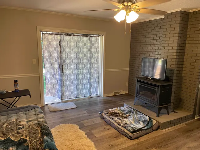 a living room with furniture and a fireplace