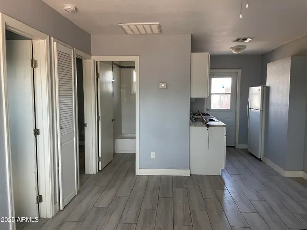 a view of a refrigerator in kitchen and wooden floor