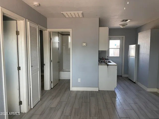 a view of a refrigerator in kitchen and wooden floor