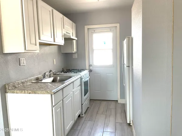 a kitchen with a sink stove and refrigerator