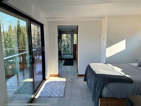 518 Container Way Boulder Creek, CA 95006 - Photo 7 of 33 a bedroom with a bed and large window