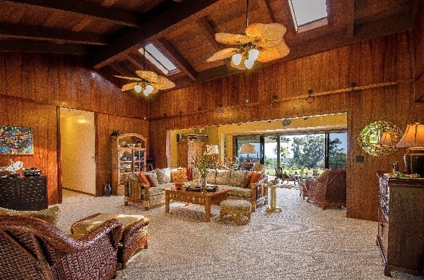 550 Akolea Road Hilo, HI 96720 - Photo 5 of 25 a living room with furniture a chandelier and a fireplace
