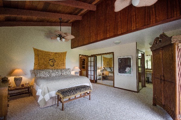 550 Akolea Road Hilo, HI 96720 - Photo 7 of 25 a spacious bedroom with a bed and wooden floor