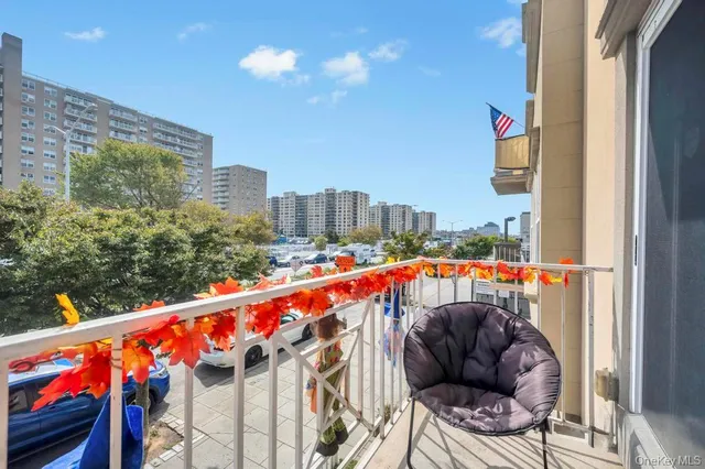 a kitchen with stainless steel appliances granite countertop a sink a stove a refrigerator white cabinets and wooden floor