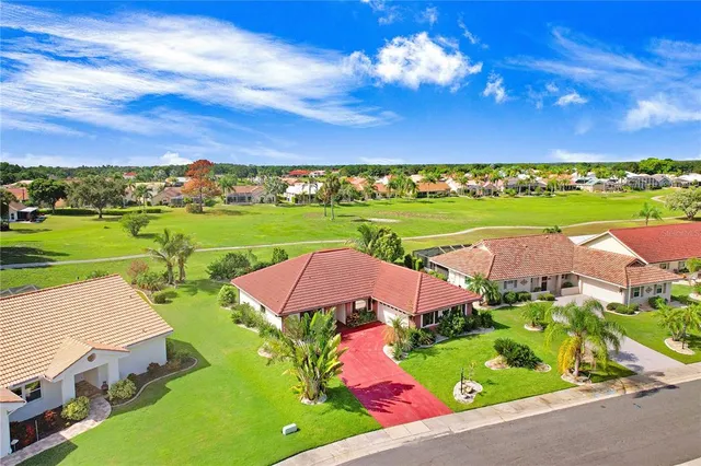 an aerial view of a house with outdoor space lake view and mountain view
