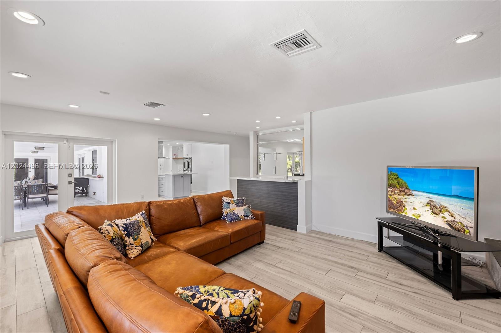 6875 North Cartee Road Palmetto Bay, FL 33158 - Photo 22 of 42 a living room with furniture and a flat screen tv
