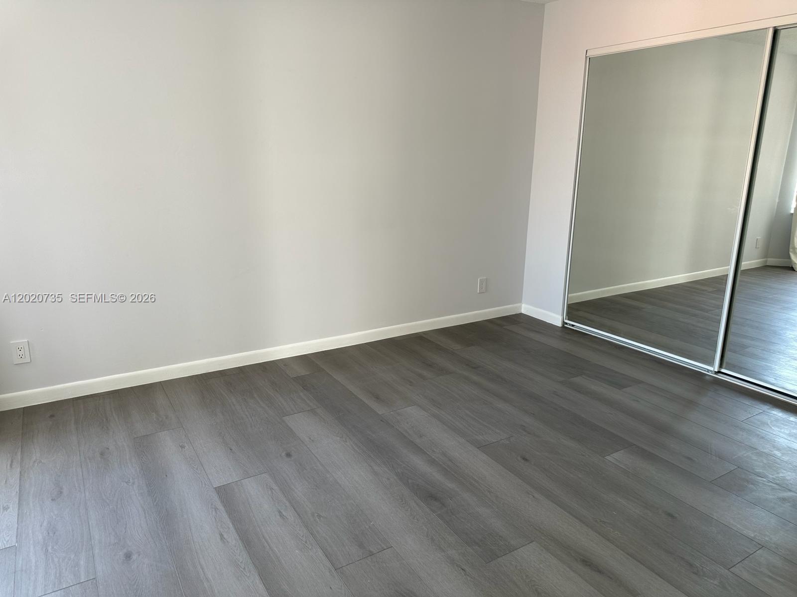 17244 Balboa Point Way Boca Raton, FL 33487 - Photo 28 of 66 an empty room with wooden floor and door