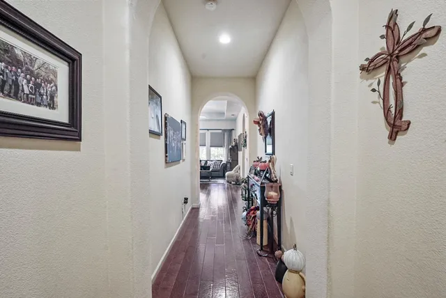 a view of a hallway with wooden floor