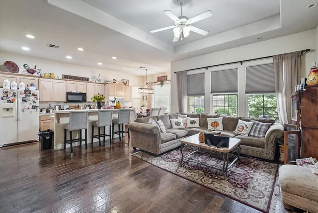 a living room with fireplace furniture and a large window