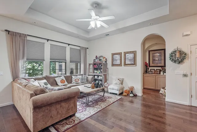 a living room with furniture and wooden floor