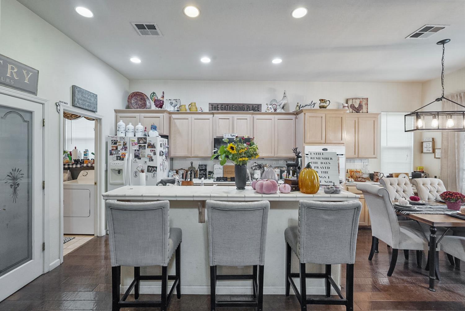 191 Fall Avenue Patterson, CA 95363 - Photo 14 of 31 a kitchen with stainless steel appliances a dining table chairs and white cabinets