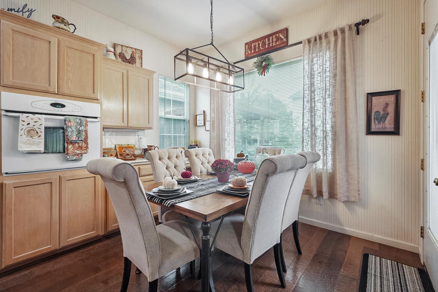 191 Fall Avenue Patterson, CA 95363 - Photo 15 of 31 a dining room with furniture a chandelier and wooden floor