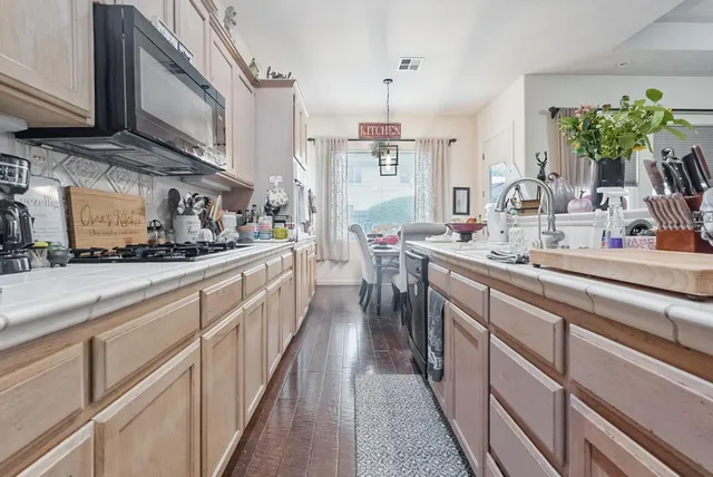 a kitchen with stainless steel appliances kitchen island granite countertop lots of counter top space and cabinets