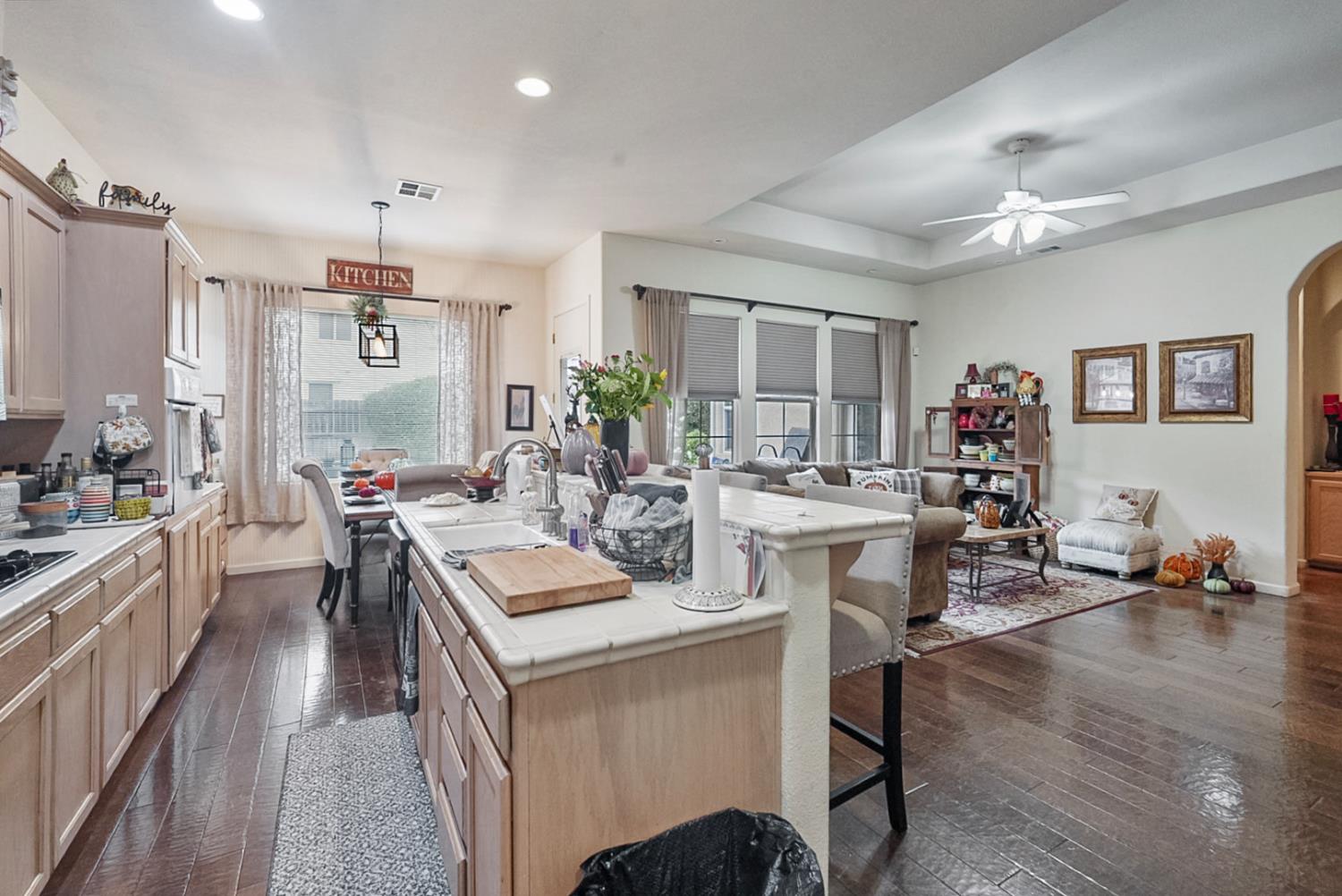 191 Fall Avenue Patterson, CA 95363 - Photo 19 of 31 a kitchen with a dining table chairs refrigerator and cabinets