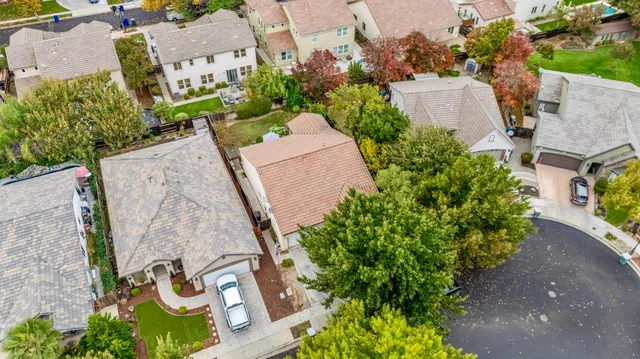 an aerial view of a house with a yard and garden