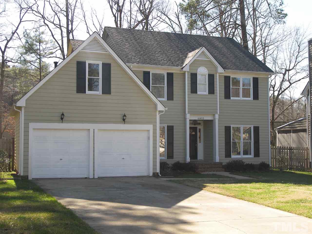 11933 Fairlie Place Raleigh, NC 27613 - Photo 1 of 25 a front view of a house with a yard and garage
