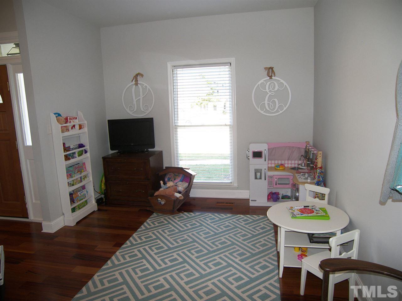 11933 Fairlie Place Raleigh, NC 27613 - Photo 10 of 25 a room that has a couch chair and a window