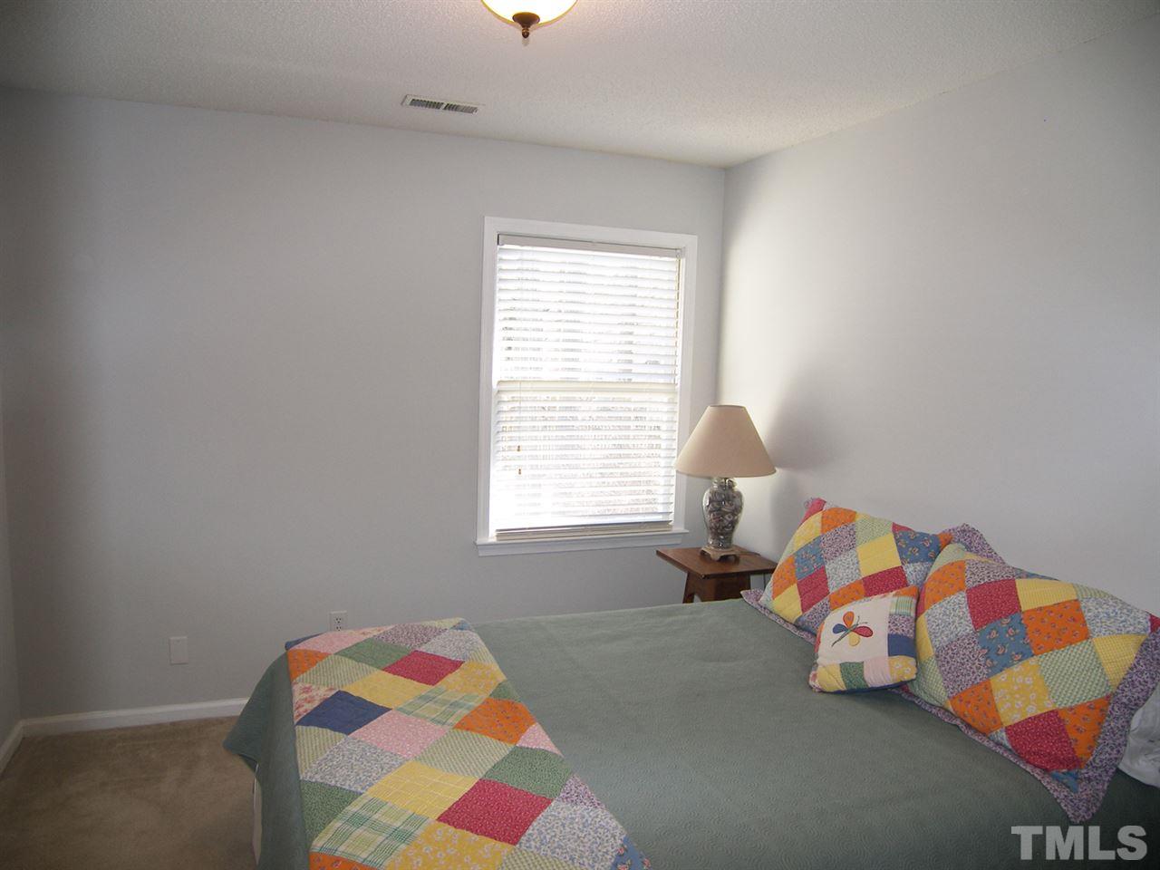 11933 Fairlie Place Raleigh, NC 27613 - Photo 18 of 25 a bedroom with a bed and a window