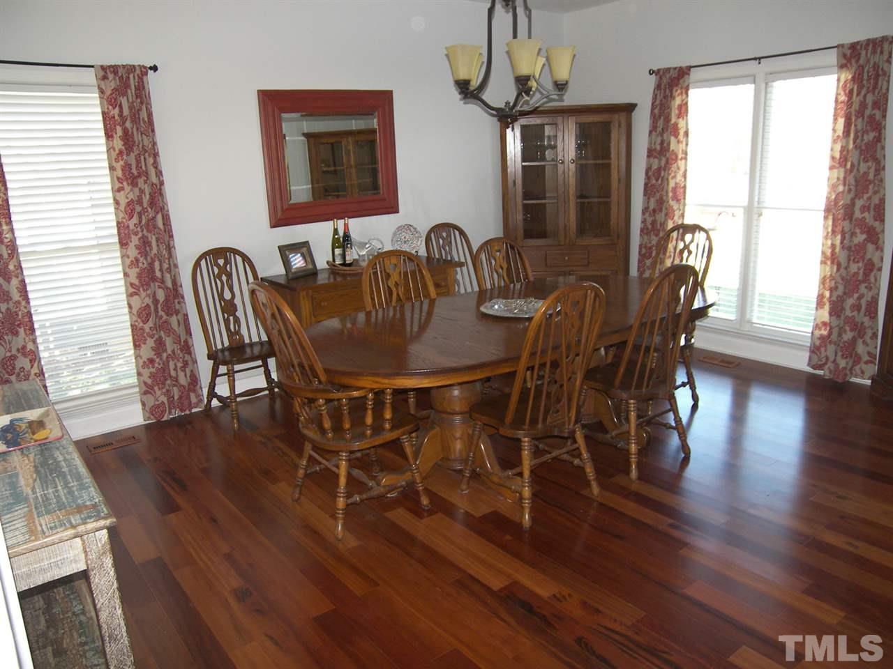 11933 Fairlie Place Raleigh, NC 27613 - Photo 3 of 25 a view of a dining room with furniture window and wooden floor