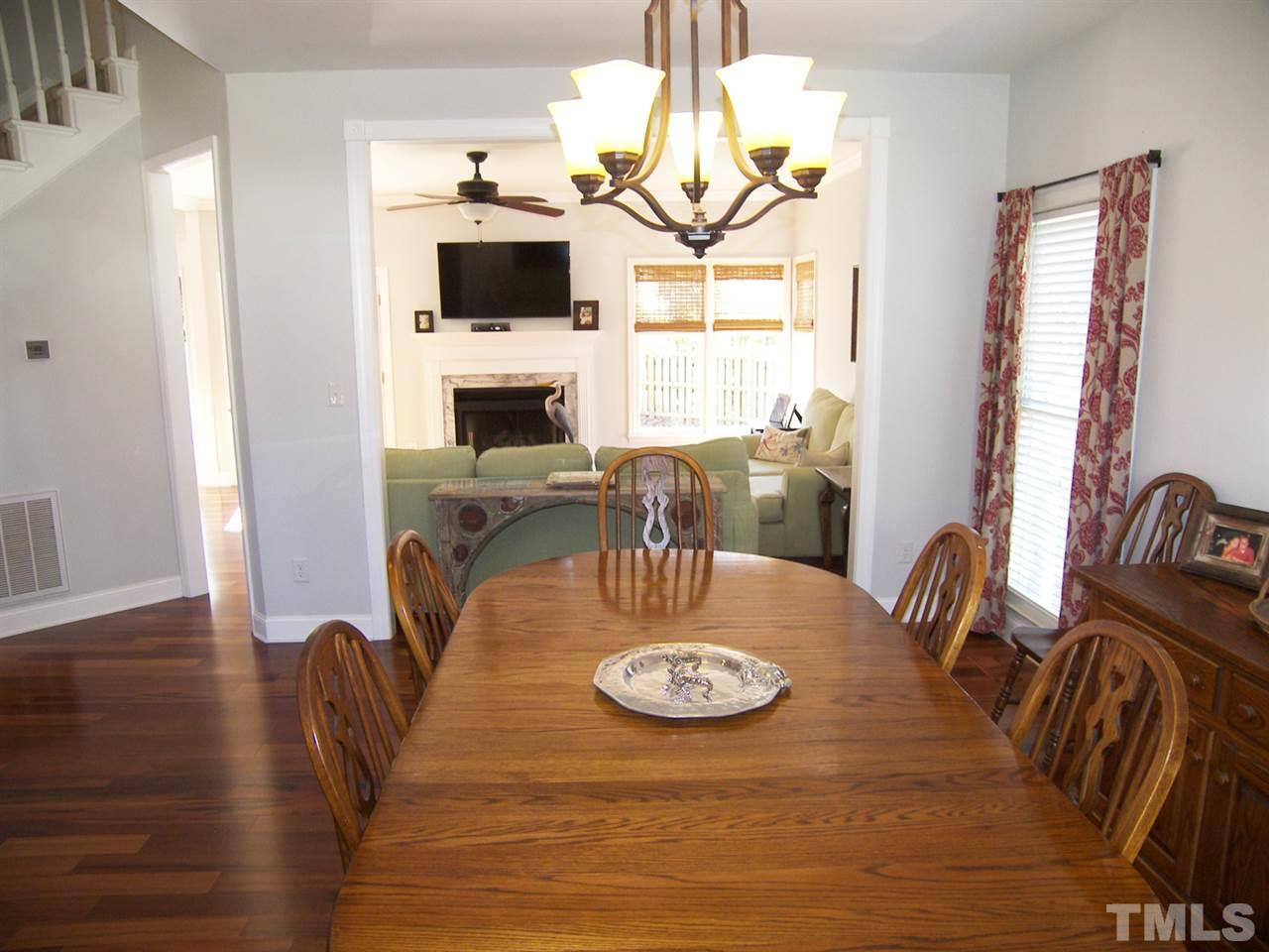 11933 Fairlie Place Raleigh, NC 27613 - Photo 4 of 25 a view of a dining room with furniture window and wooden floor