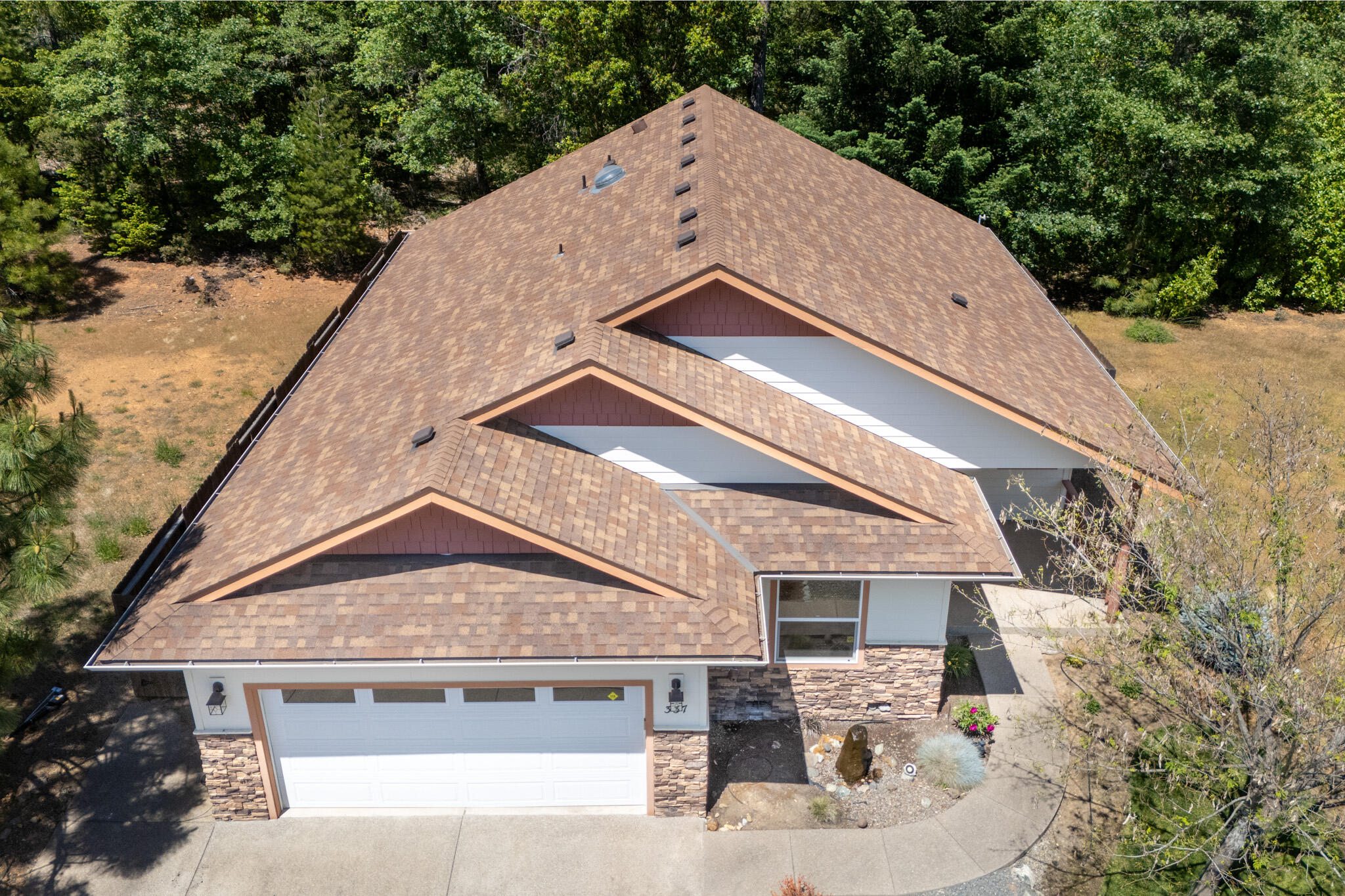 337 Cedar Ridge Drive Cave Junction, OR 97523 - Photo 3 of 56 a front view of a house with trees