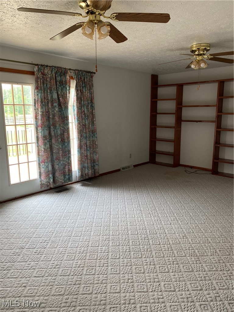 36889 Capel Road Grafton, OH 44044 - Photo 10 of 26 Empty room featuring ceiling fan, carpet flooring, a textured ceiling, and baseboards