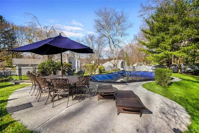 a view of a backyard with sitting area