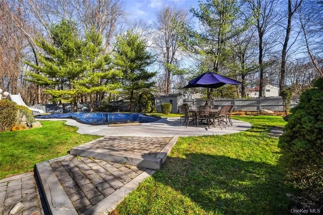 a swimming pool with outdoor seating yard and green space