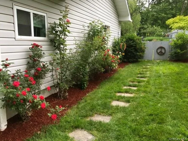 a view of a house with a yard and garden
