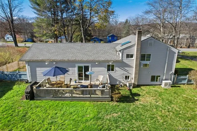 a view of a house with a yard and sitting area