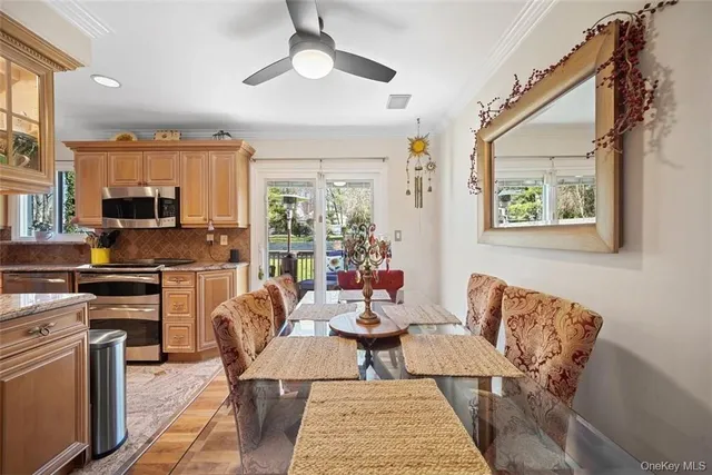 a outdoor space with furniture a large window and stainless steel appliances