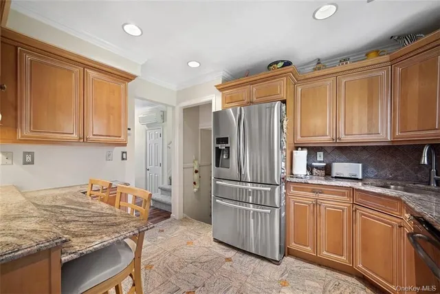 a kitchen with stainless steel appliances granite countertop a refrigerator sink and cabinets
