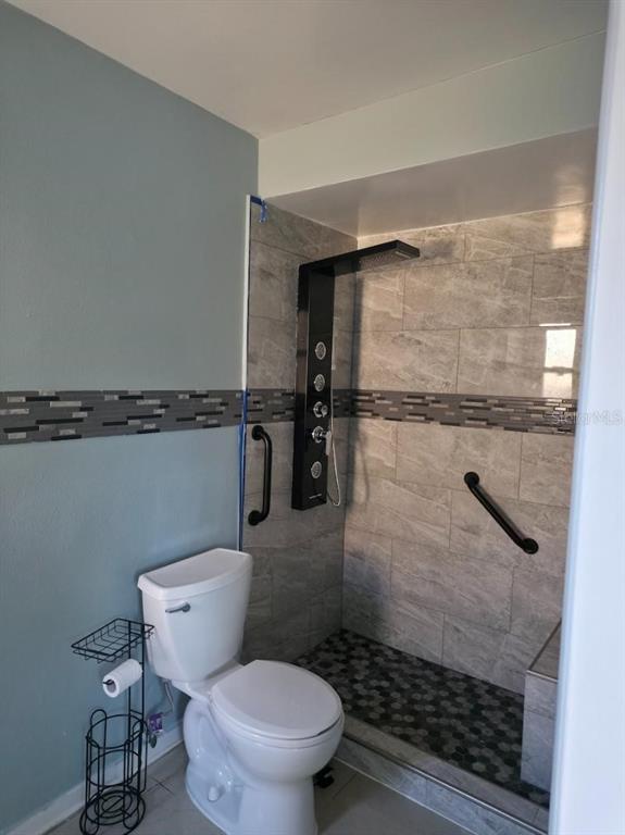 2111 North Keene Road Clearwater, FL 33763 - Photo 13 of 35 a bathroom with a toilet and a shower