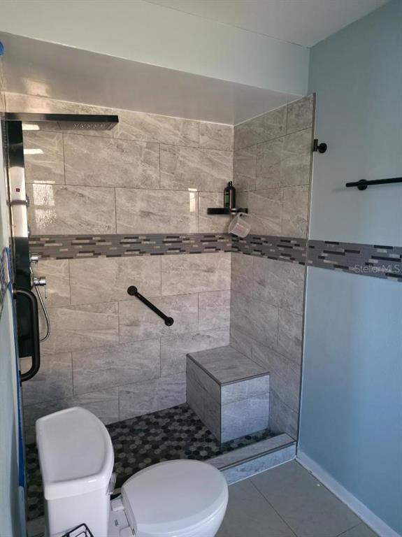 2111 North Keene Road Clearwater, FL 33763 - Photo 14 of 35 a bathroom with a toilet and a shower