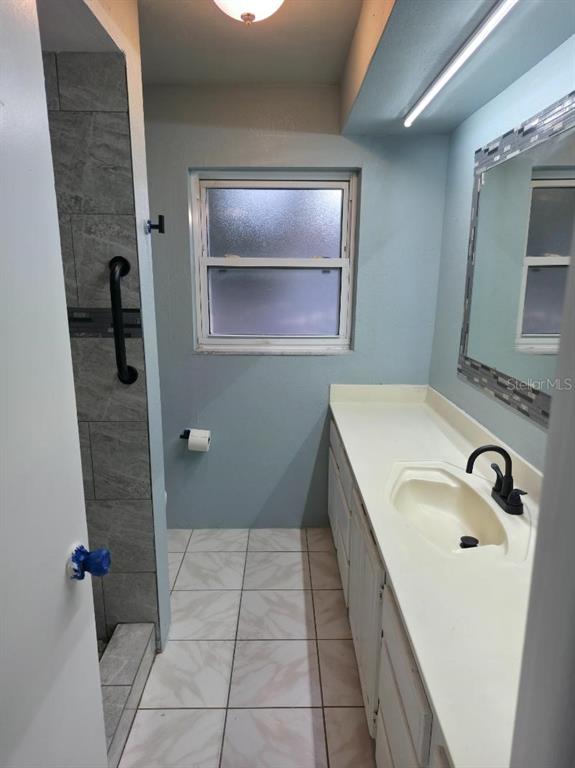 2111 North Keene Road Clearwater, FL 33763 - Photo 23 of 35 a bathroom with a sink and mirror