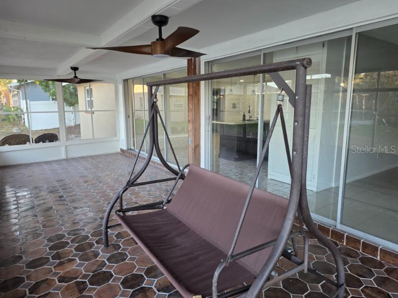 2111 North Keene Road Clearwater, FL 33763 - Photo 33 of 35 a living room with a couch and a floor to ceiling window